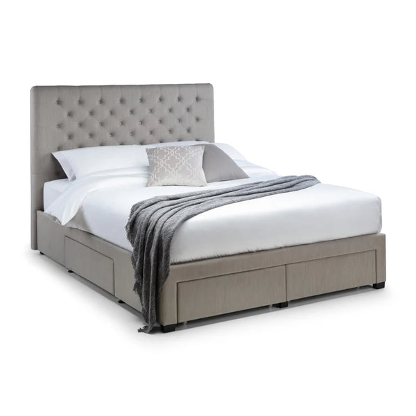 Gray upholstered bed with white bedding and a gray throw blanket on a white background