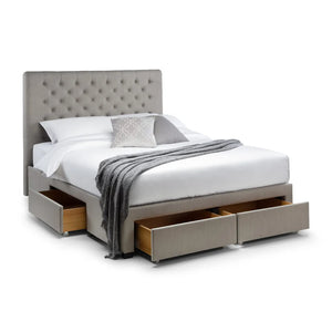 Gray upholstered bed with storage drawers on a white background