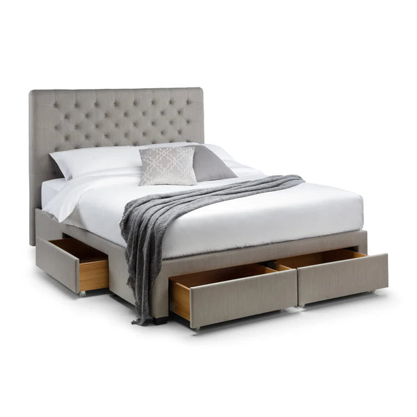 Gray upholstered bed with storage drawers on a white background