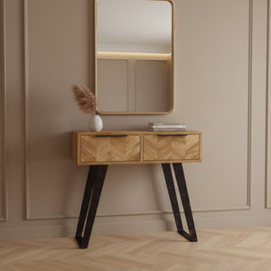 Wooden console table with black metal legs on a white background