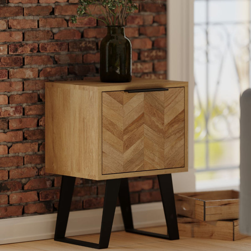 Wooden side table with chevron pattern and black metal legs on a white background