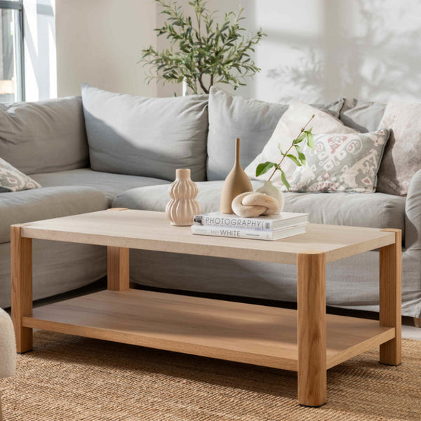 Living room with a gray sofa, wooden coffee table, and decorative items.