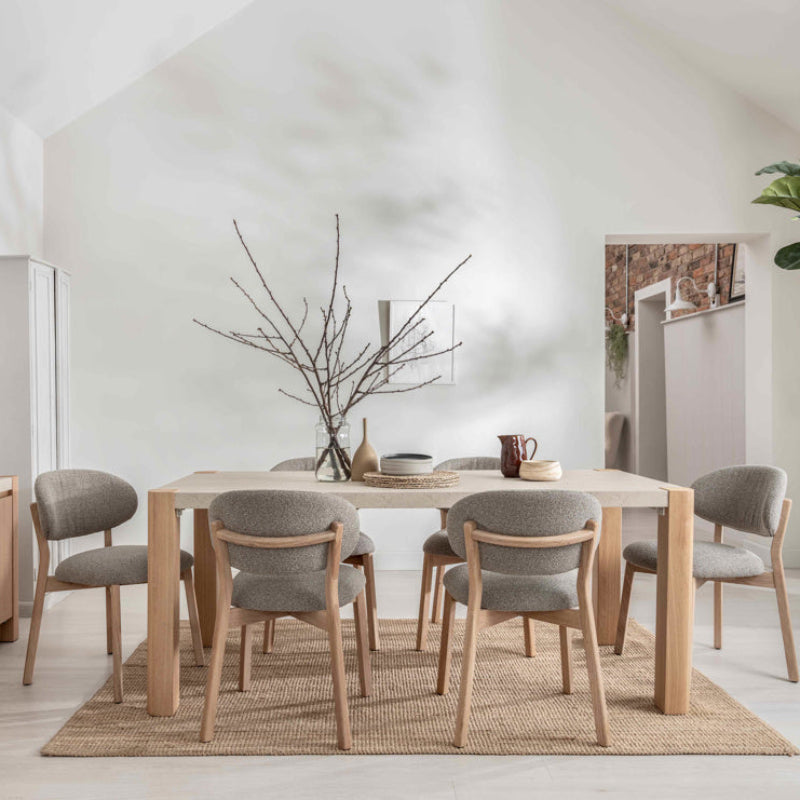 Rectangular table with light wood legs and beige top on a white background