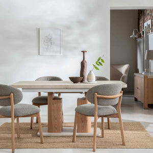 Dining area with wooden table and chairs in a modern home setting.