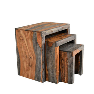 Set of three wooden nesting tables with a rustic finish on a white background