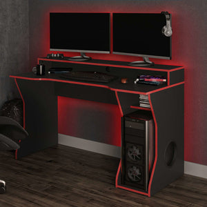Gaming desk with dual monitors, gaming chair, and accessories in a room setting.