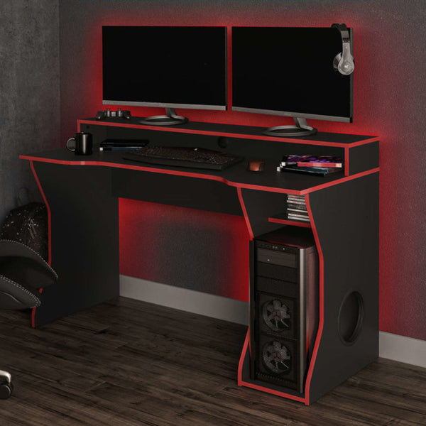 Gaming desk with dual monitors, gaming chair, and accessories in a room setting.