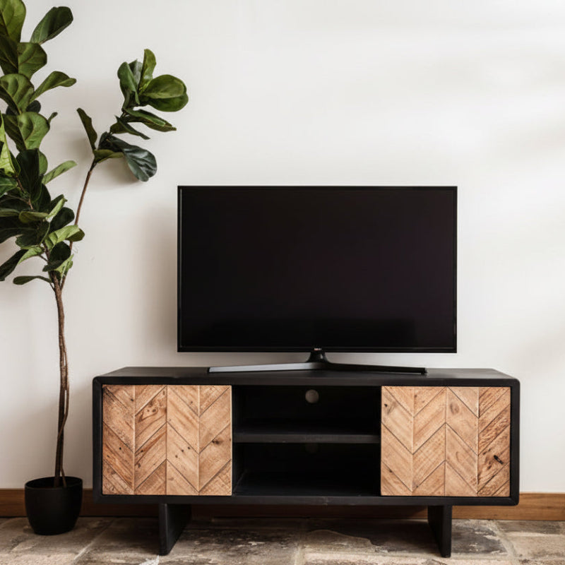 Black TV stand with wooden chevron pattern doors on a white background
