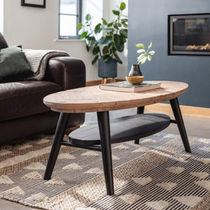 Wooden coffee table in a living room with a sofa and decorative items.