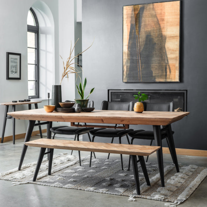 Wooden dining table with black legs on a white background