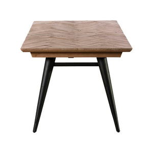 Square table with herringbone wooden top and black metal legs on a white background
