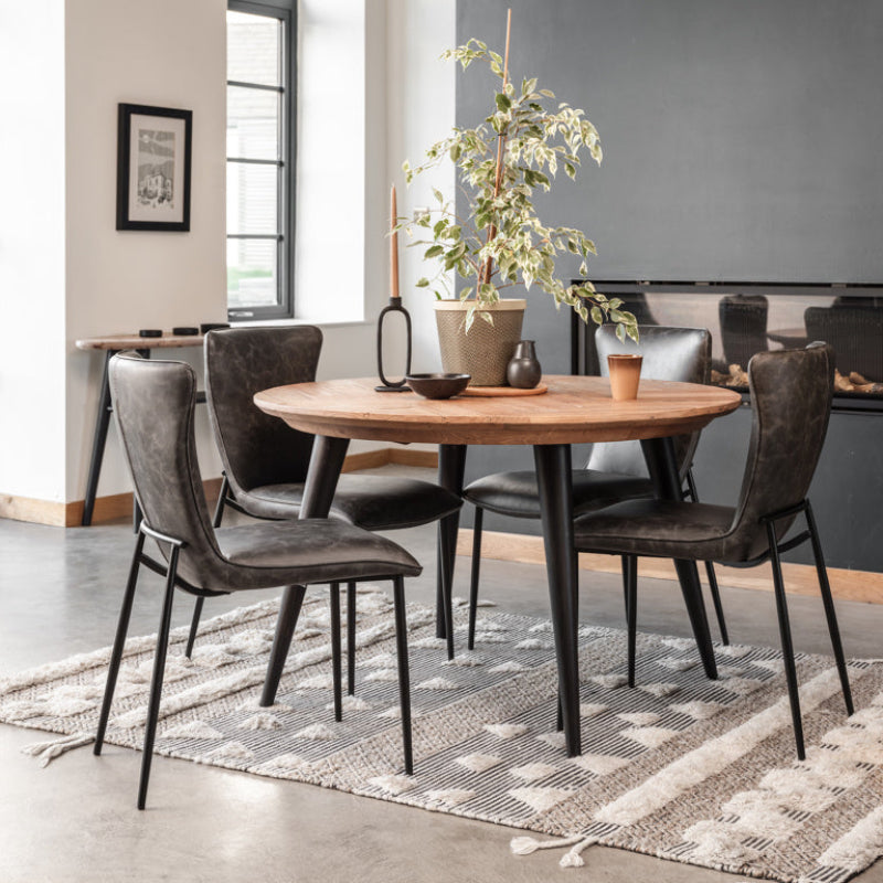 Round wooden table with black legs on a white background