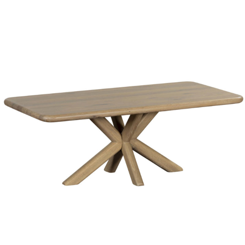 Wooden dining table with a unique base design on a white background