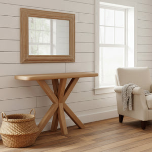 Wooden console table in a room with a mirror, chair, and basket.