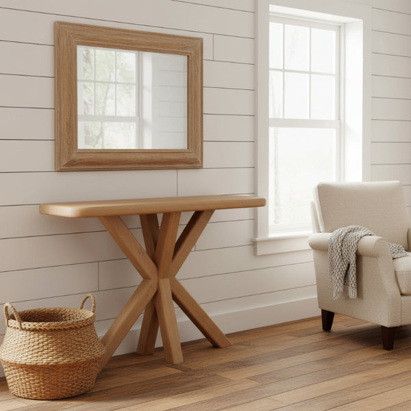 Wooden console table in a room with a mirror, chair, and basket.