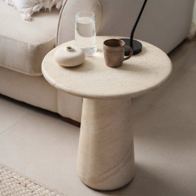 Beige side table with a cylindrical base on a white background