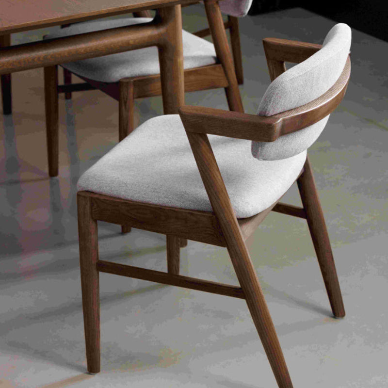Chair with wooden frame and gray cushion on a white background