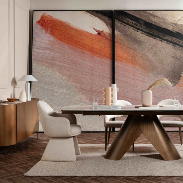 Modern dining room with a wooden table and chairs, large abstract paintings on the wall, and a sideboard.