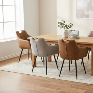 Dining room with a wooden table and chairs on a light rug.