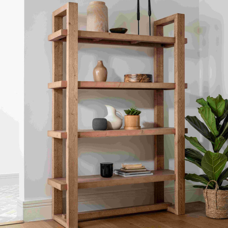 Wooden bookshelf with four shelves on a white background