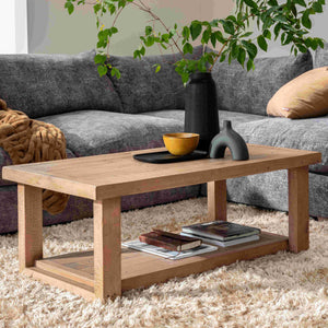 Wooden coffee table with decorative items in a living room setting