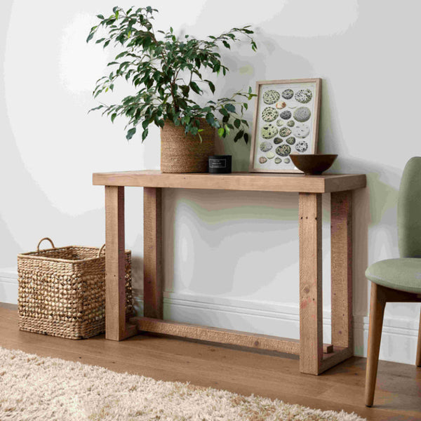 Wooden console table with decorative items in a room setting