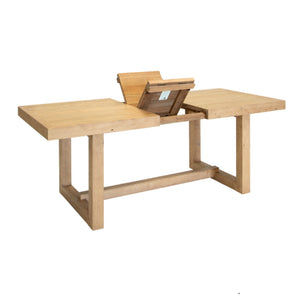 Wooden dining table with an extended leaf on a white background