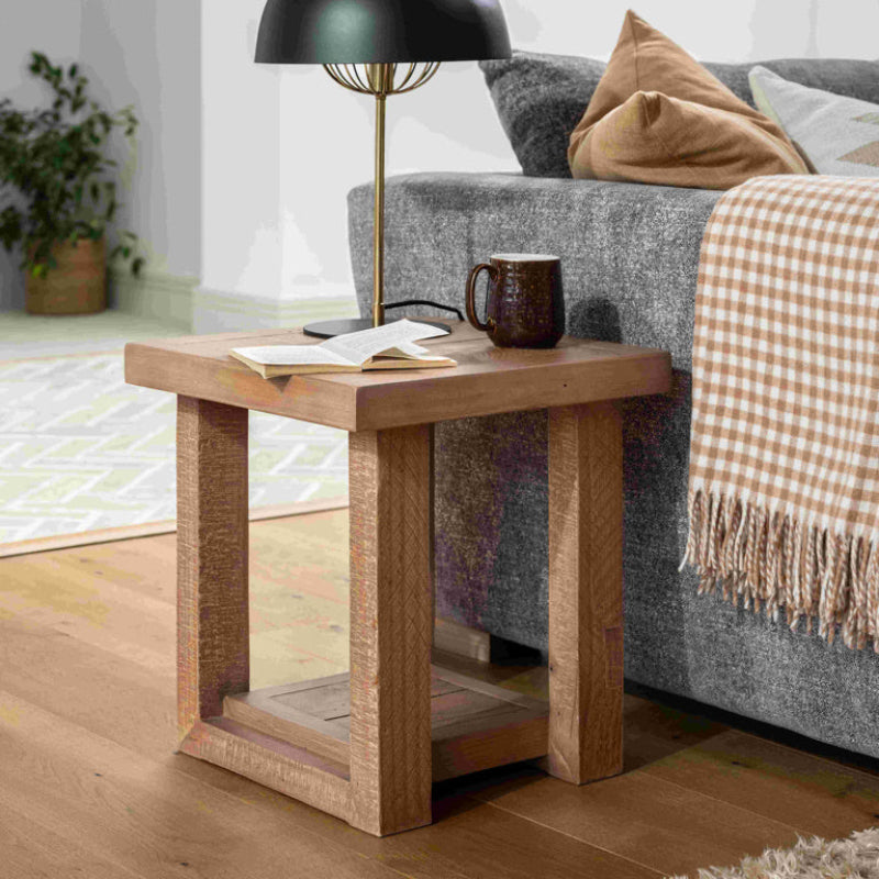 Wooden side table with a natural finish on a white background