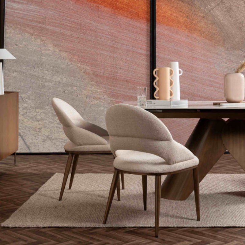 Beige upholstered chair with wooden legs on a white background