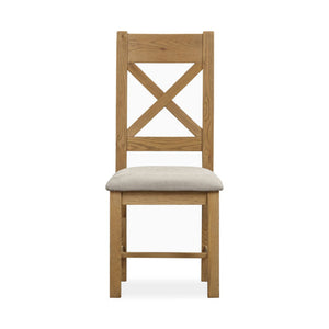 Wooden chair with a beige cushion on a white background