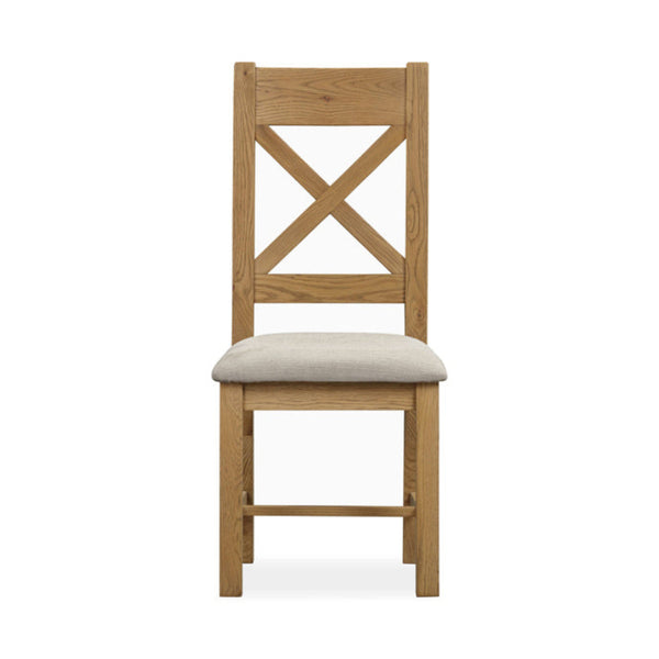Wooden chair with a beige cushion on a white background