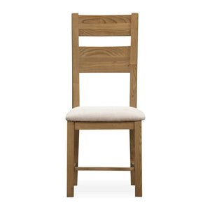 Wooden chair with a white cushion on a white background