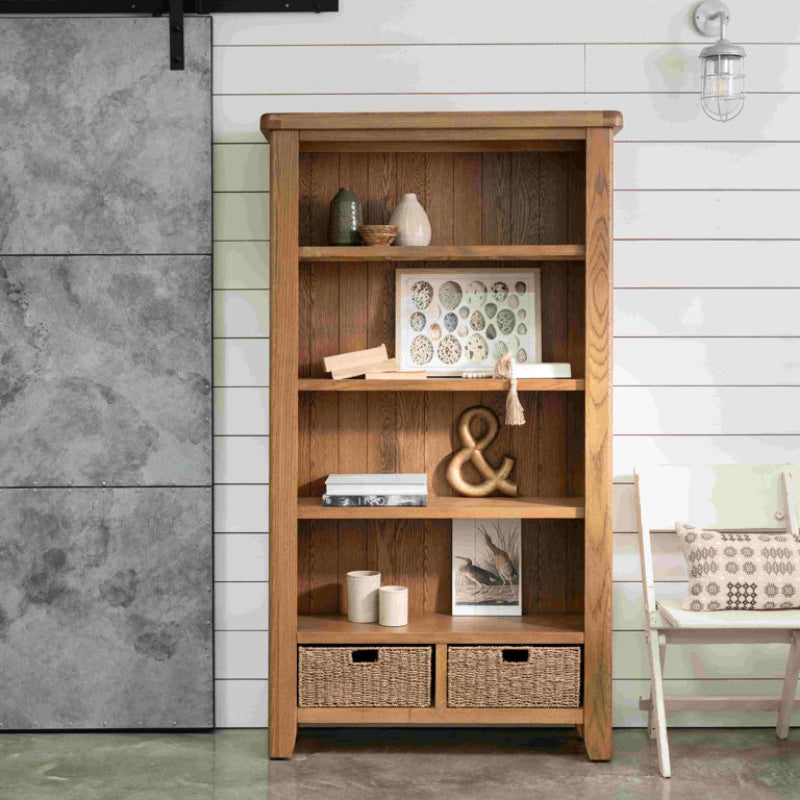 Wooden bookshelf with two basket drawers on a white background