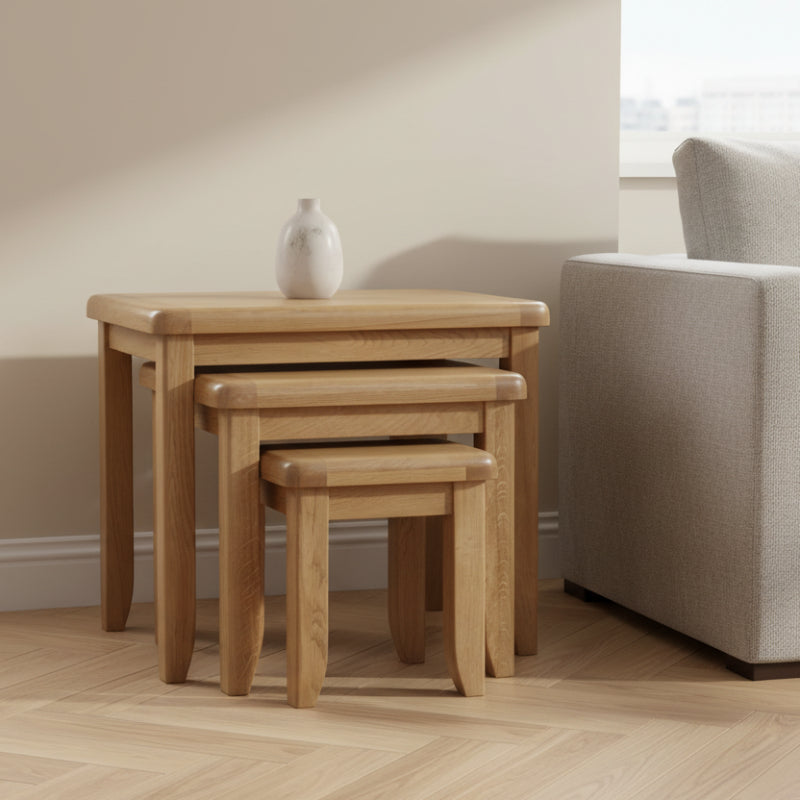 Set of three wooden nesting tables on a white background